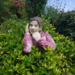 Figure in the shrubbery in French garden