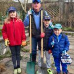 Ready to do some seed planting. Me with grandkids, Maya, Banks and Jake.